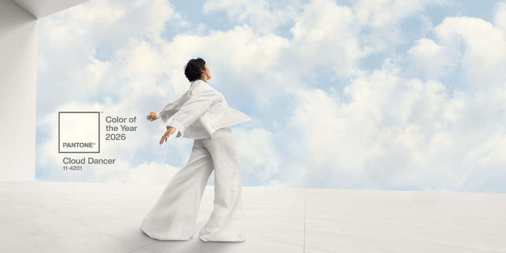 A woman wearing white dances near the clouds.