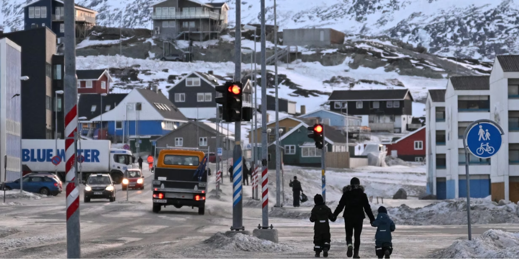 A family in Greenland walk in their neighborhood.