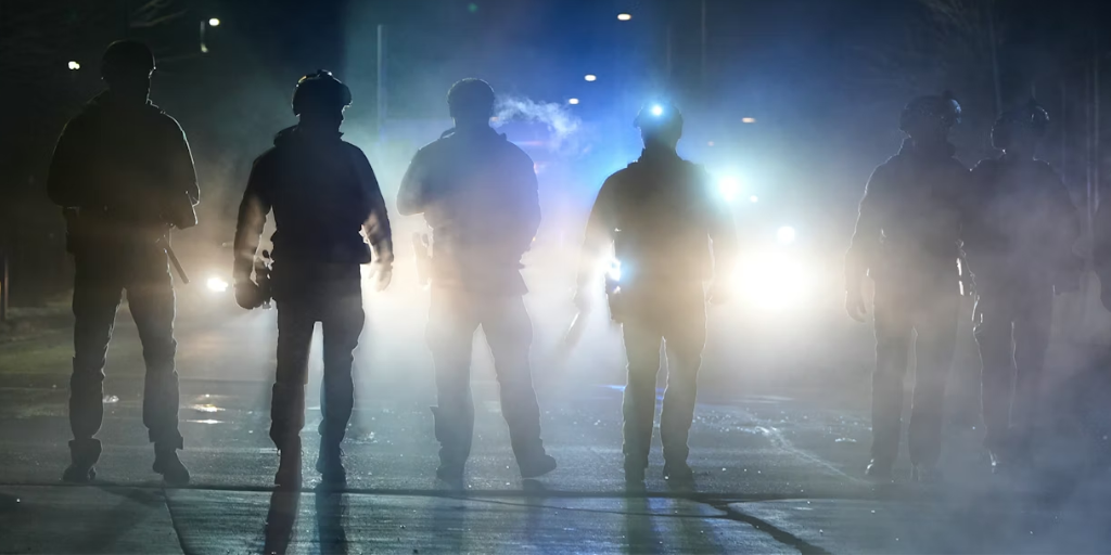 Federal immigration officers are seen outside the Bishop Whipple Federal Building in Minneapolis on Jan. 12, 2026. AP Photo/Jen Golbeck
